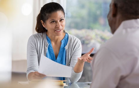 Medical researcher interviews volunteer