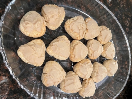A plate of small lemon scones on a table.