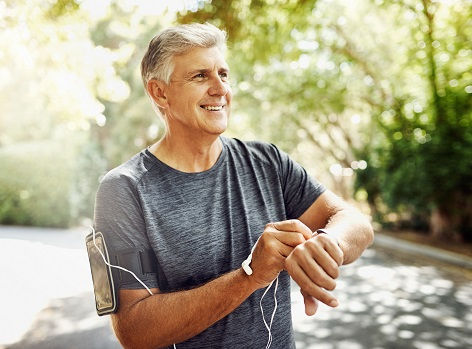 Mature man checks his pulse after a workout.