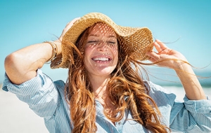 women with red hair in a wide brim sun hat