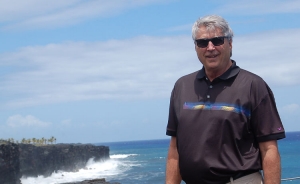 Joe P stands at the beach.