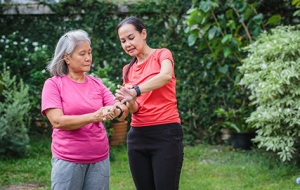 two women check their heart rate using smart watches