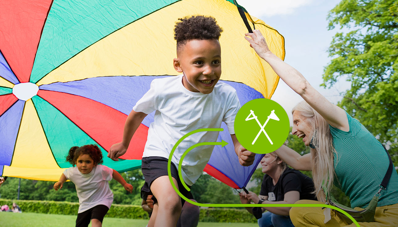 Children at summer camp play the parachute game.