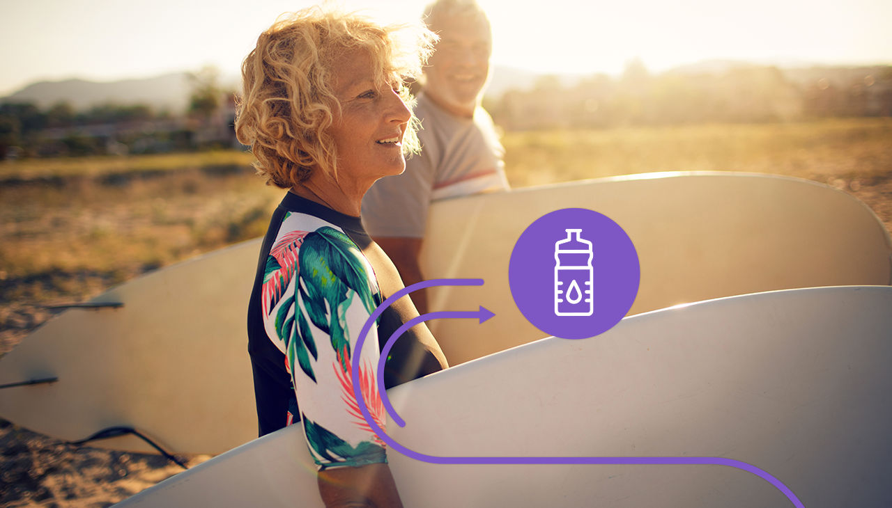 An older woman prepares to go surfing.