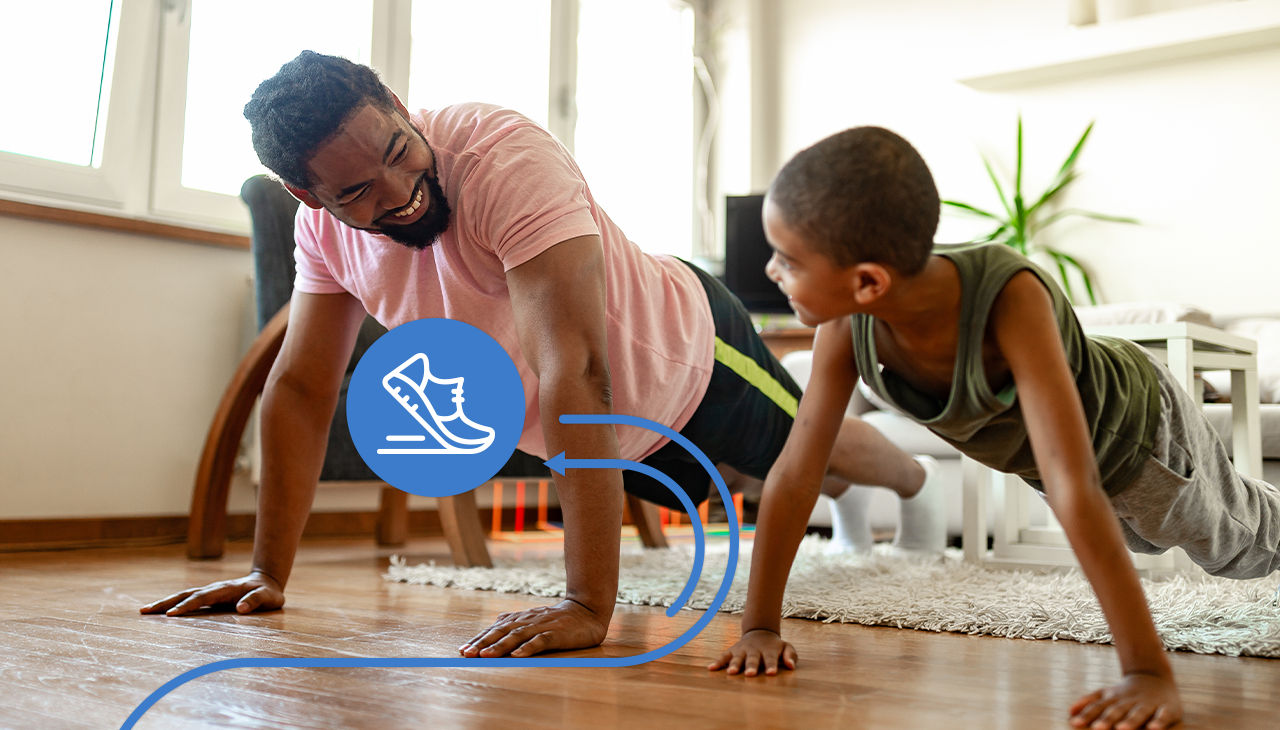 A father and son do push-ups together.