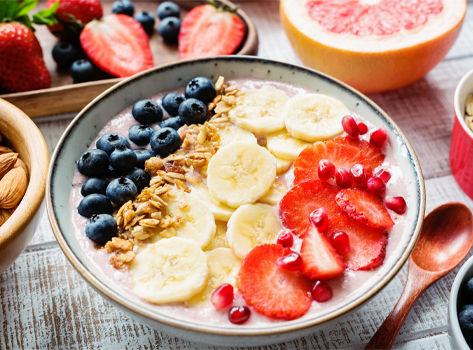 Bowl of colorful fruit, grains and yogurt