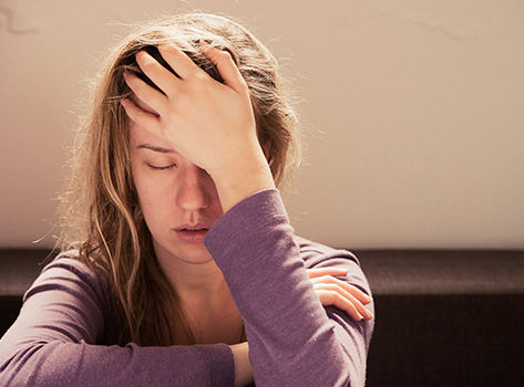 A woman struggles with fatigue from long COVID.