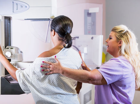 A woman getting a mammogram.