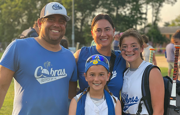 Phil O. stands with his family after a ball game.