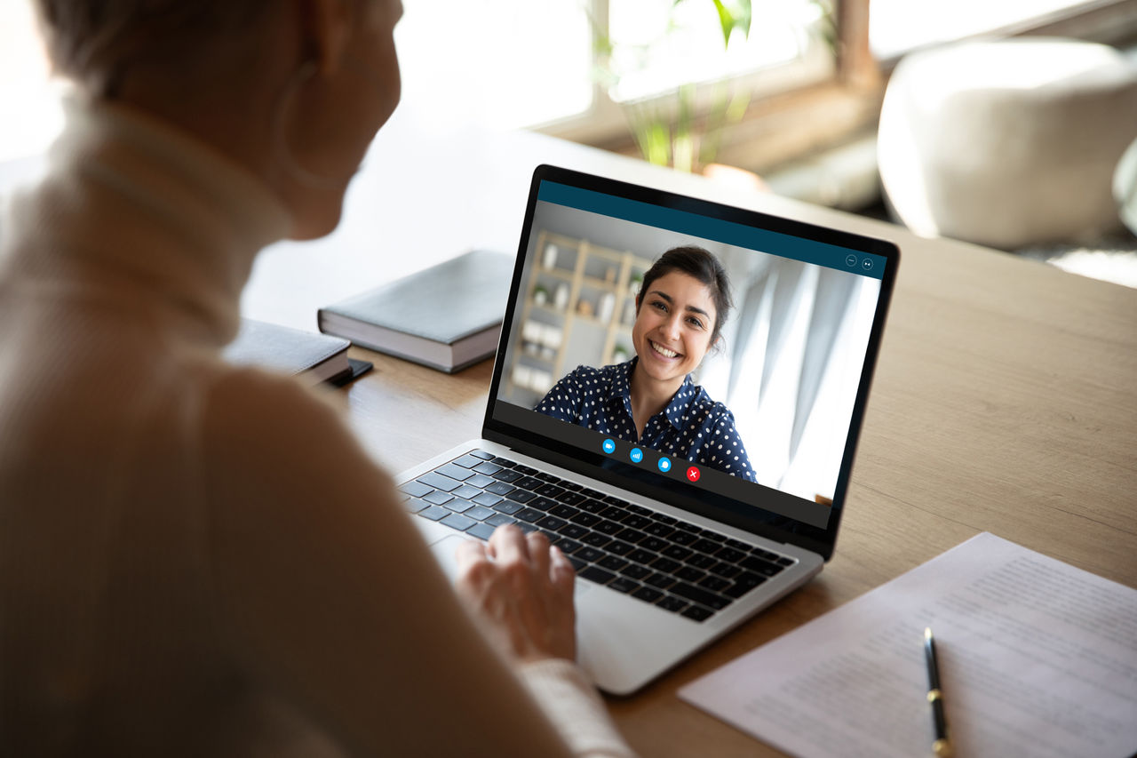 doctor discusses cancer resources to patient on tablet