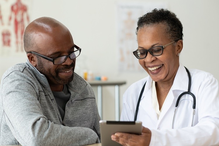 Doctor explains cancer services to patient