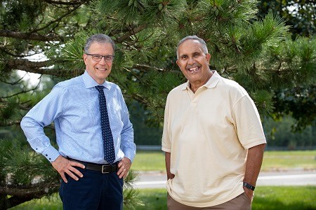 Dr. Cerrone and Gregory E  stand together, smile.