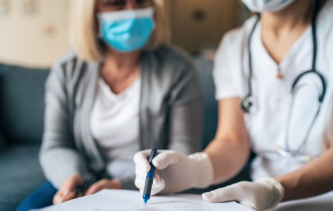 doctor shows cancer resources to patient on tablet