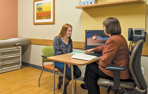 Teenage girl speaks with a child development specialist