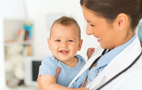 Infant being held by doctor