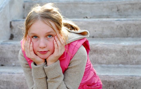 Pediatric rheumatology patient sits on steps