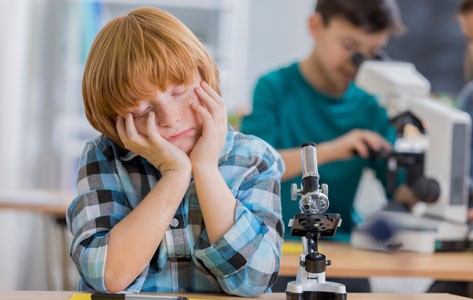 Boy falls asleep in school lab