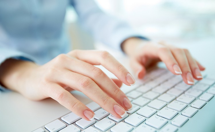 A woman's fingers on a keyboard