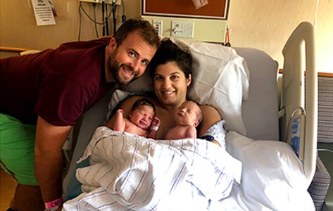 Kristen K. cuddles her twins in a maternity bed at Chilton Medical Center in New Jersey.