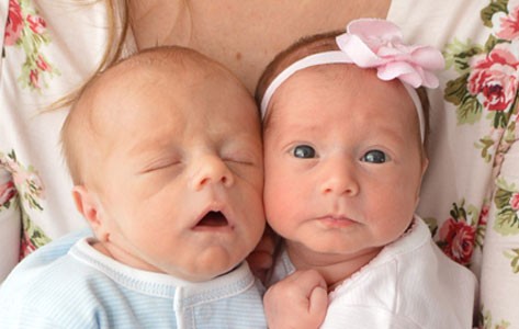 Young woman holding newborns