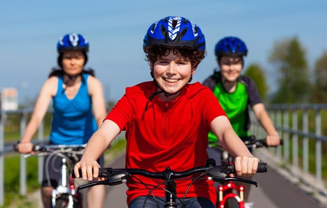 three children riding bikes