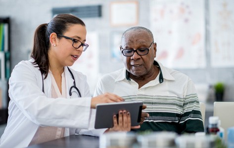 doctor instructs patient on tablet