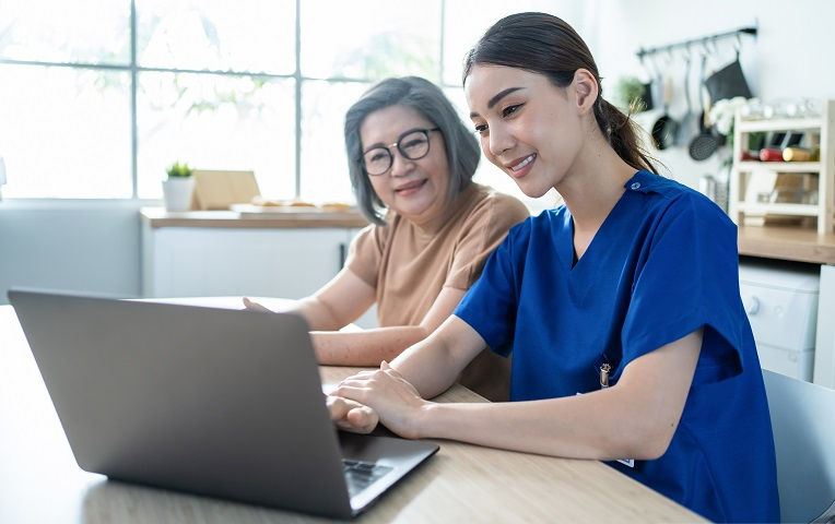 Clinician reviews health resources with a senior patient.