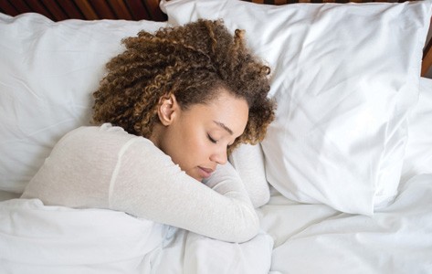 Woman with sleep disorder resting in bed