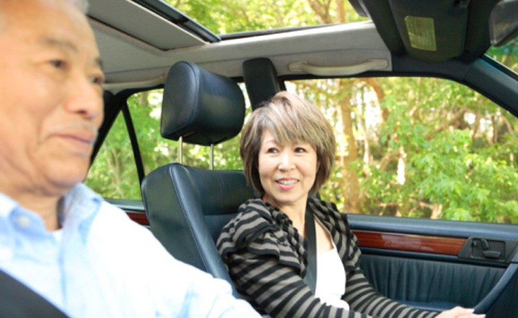 Asian couple driving