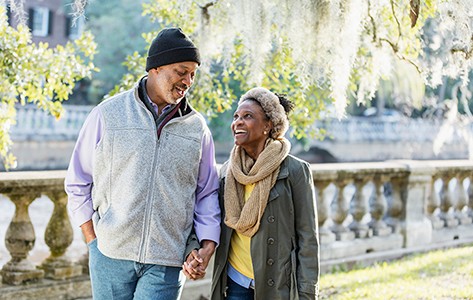 Man and woman holding hands walking