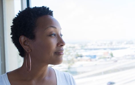 African American woman looking out the window