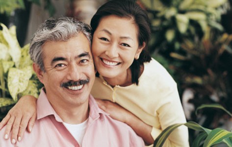 Woman posing with man and flowers