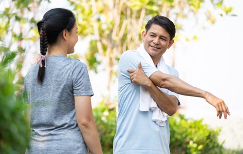 middle-aged couple stretching