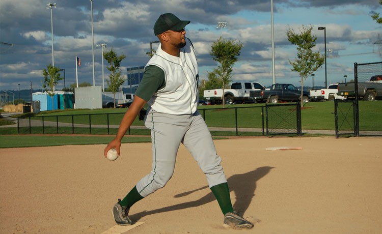 Man pitching softball