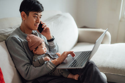 Father and baby on couch