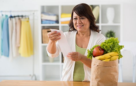 woman reviewing her grocery shopping receipt