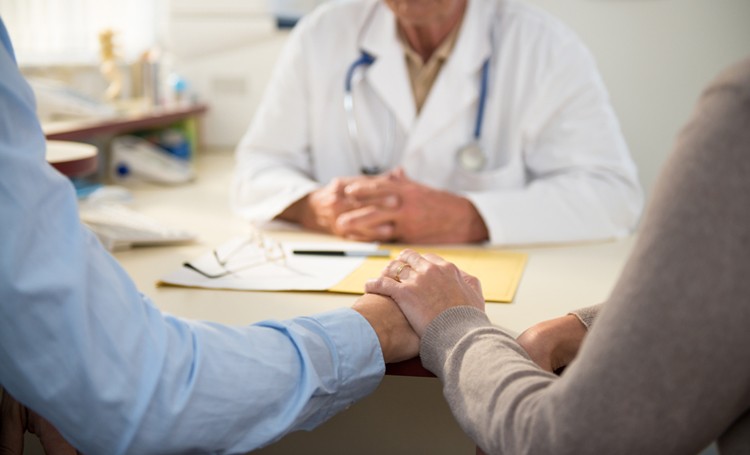 Surgeon talking to couple 