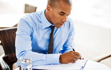 man filling out forms