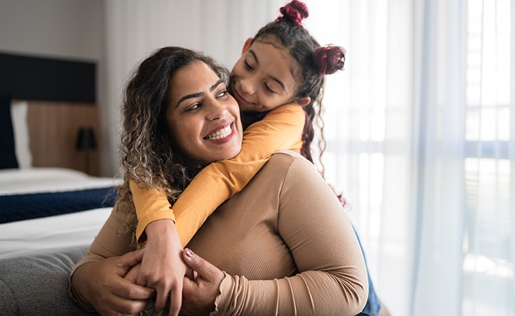 Daughter hugging mother