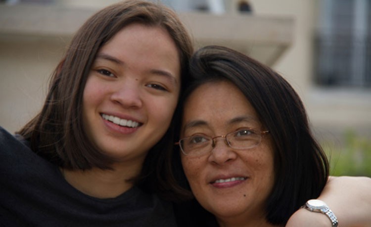 Daughter hugging mother