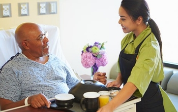 Hospital patient receiving meal during stay