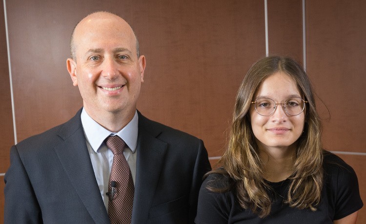 Sam K., and spine surgeon Dr. Jason Lowenstein, stand next to each other.