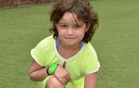 Juliet smiles on her lawn after successfully battling leukemia.