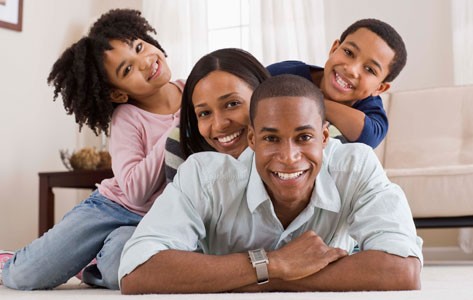 A mom, dad and two kids pose together