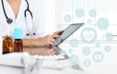 A physician scrolls through her laptop, researching medications.