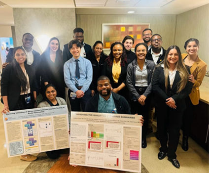 Residents stand in front of an internal medicine research project.