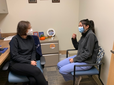 An internal medicine resident meets with her mentor.